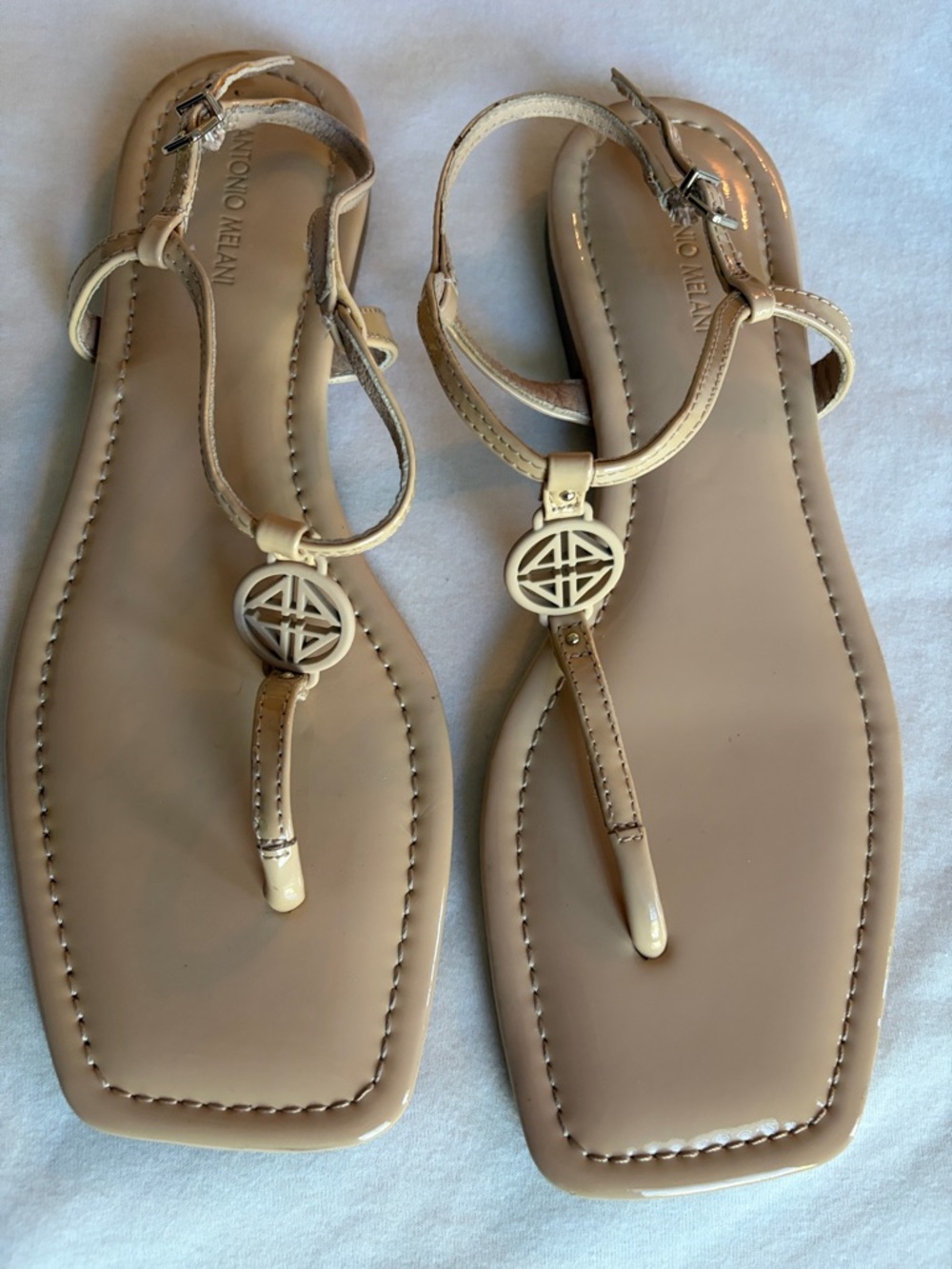 ANTONIO MELANI Beige Patent T-Strap Sandals with Gold Medallions